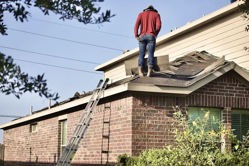 Professional roofer working on a residential roof in Strafford